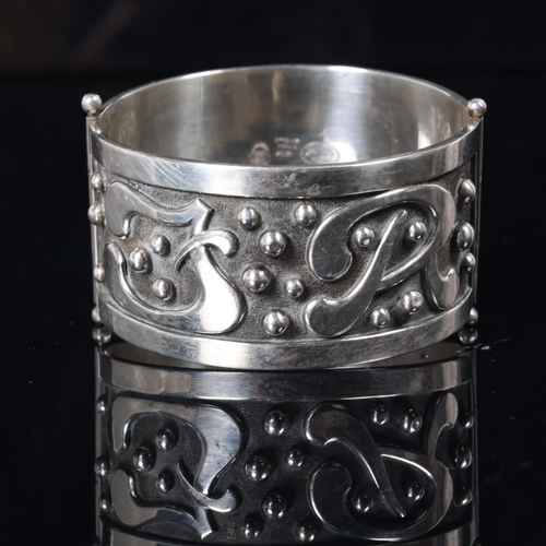 1468 - VIGGO MARTENSEN - a heavy Danish modernist sterling silver hinged bangle, with applied stylised init... 