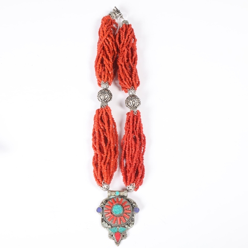 1491 - A Tibetan multi-strand coral bead necklace, with white metal coral pendant, pendant 59.5mm, necklace... 