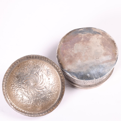 1580 - An Indian Mughal silver pandan/betel box and cover, circular form with relief embossed floral decora... 