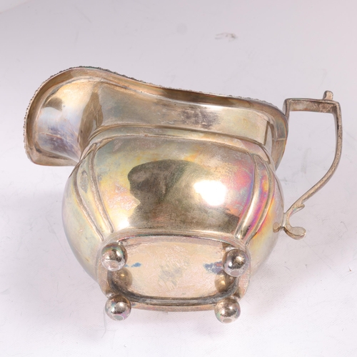 1613 - A George V silver cream jug, C S Harris & Sons Ltd, Birmingham 1910, bulbous form, with gadrooned ri... 