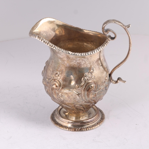 1614 - A late Victorian silver cream jug, indistinct maker, London 1898, baluster form, with relief embosse... 