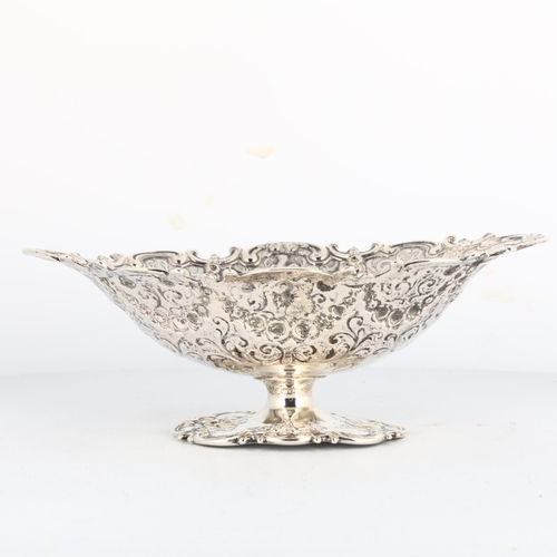 1688 - An Antique Continental 800 silver pedestal basket, oval form, with relief embossed and chased foliat... 