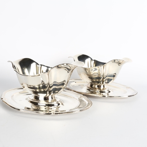 1699 - A pair of Danish silver sauce boats, retailed by Heimburger, circa 1929, shaped oval form, with doub... 