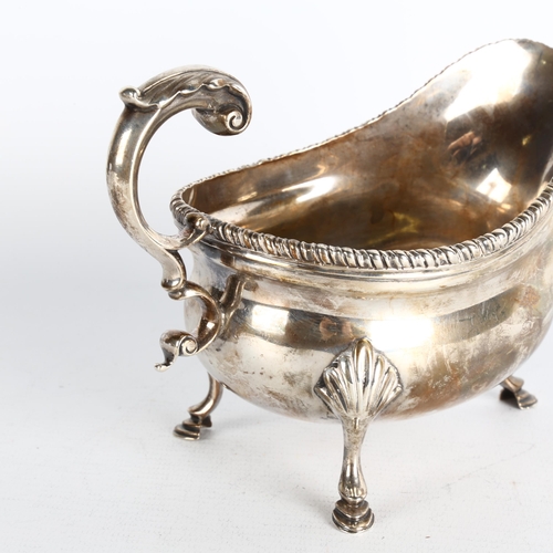 1736 - An Edwardian silver sauce boat, S W Smith & Co, London 1905, bulbous form with gadrooned rim, scroll... 