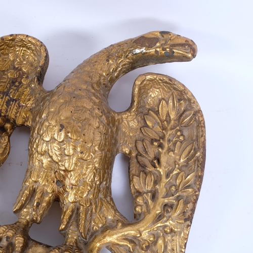 11 - A large and extremely heavy gilded cast-iron eagle pediment mount, H51cm, W43cm