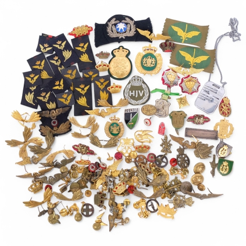 185 - A large quantity of military insignia, buttons, adornments, cloth badges, etc