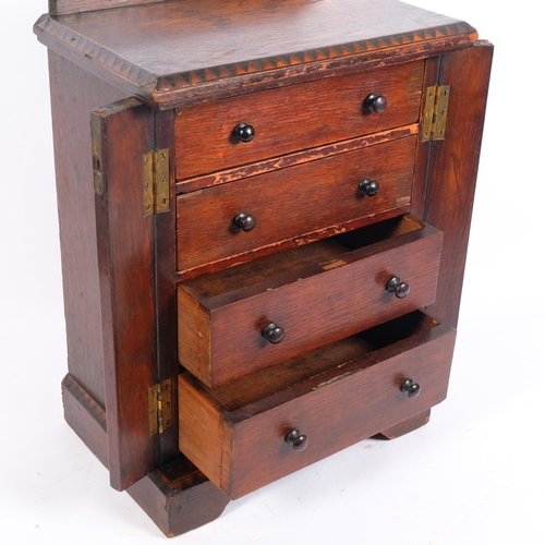 29 - An Antique stained oak apprentice piece table-top Wellington chest of drawers, W32cm, H47cm, D21cm