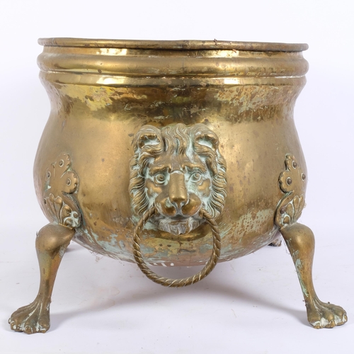 3 - WITHDRAWN - A George III brass fireside coal bucket, oval form with lion ring handles and lion paw f... 