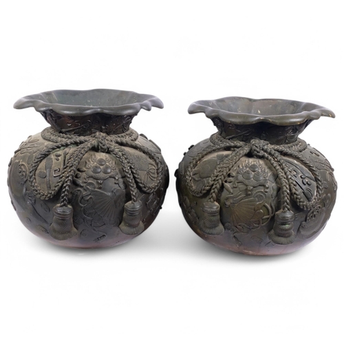 A large pair of Japanese patinated bronze 'Hotei Sack' jardinieres, Meiji Period, in the form of bags with tied rope knots and relief auspicious objects, rim diameter 40cm, height 39cm