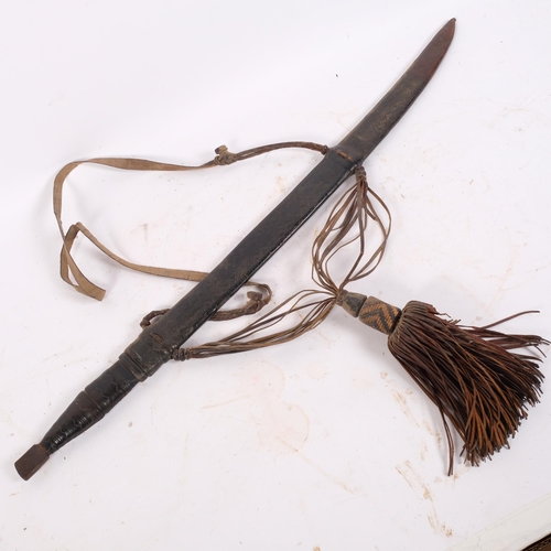 52 - An African Rhodesian Tribal short sword, with leather grip, engraved blade and leather sheath, blade... 