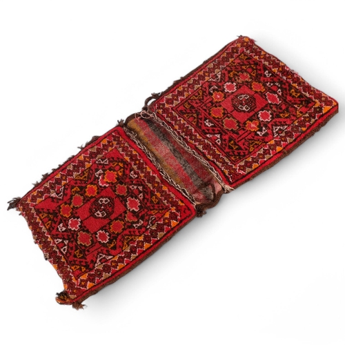 237 - A red ground Persian saddlebag