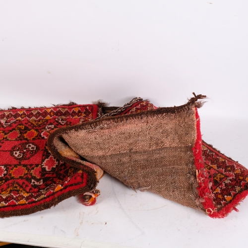 237 - A red ground Persian saddlebag