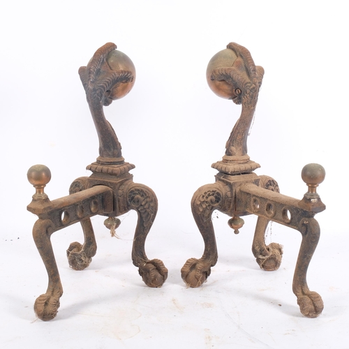 252 - A pair of Antique Gothic design cast-iron fire dogs in the form of eagles holding copper balls, H34.... 