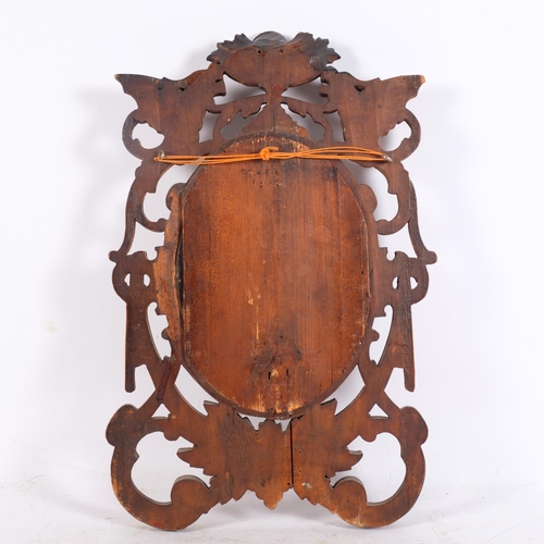 258 - A stained carved wood bevelled oval mirror, with griffon designs, H46cm