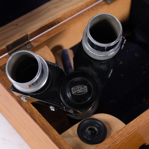 262 - A mahogany stationery rack, 35.5cm across, a Becks student's microscope in wooden case, and a carved... 