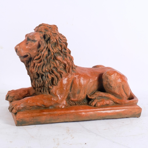 282 - A terracotta figure of a lion on rectangular plinth, L27.5cm