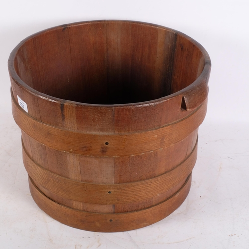 283 - A coopered oak half barrel with handles, H30.5cm