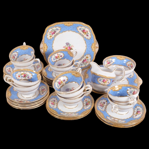 303 - Extensive Staffordshire Vintage bone china tea service, with floral decorated panels on blue ground