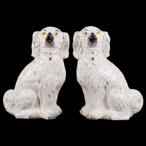 309 - A pair of large Edwardian white mantel Spaniels, 35.5cm