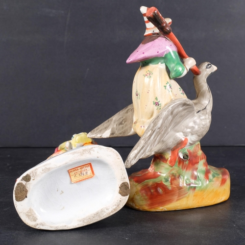 324 - Victorian Staffordshire witch riding a goose, 18cm, and a figure of a girl with a dog