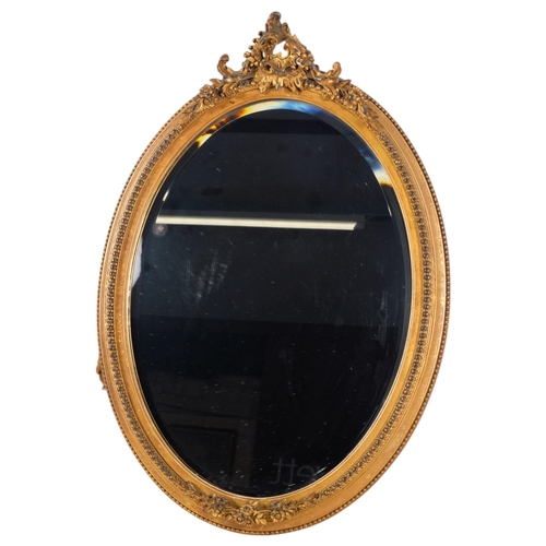 371 - WITHDRAWN - An Antique oval gilt and gesso-framed bevel-edged wall mirror, with applied decoration, ... 