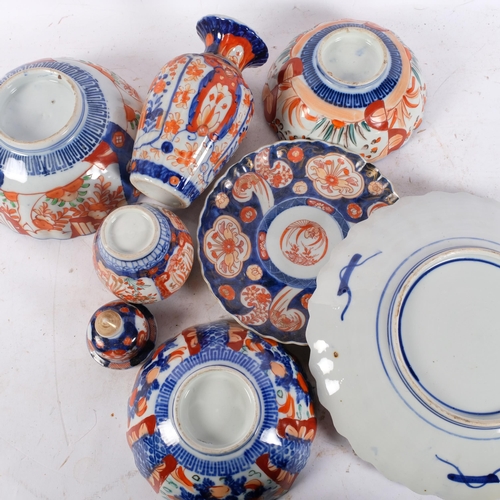 408 - A group of Imari porcelain including a vase, 19.5cm, bowls, charger, etc