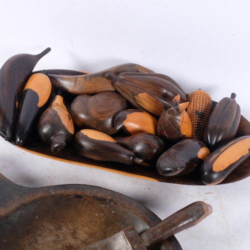 440 - An African Tribal carved wood food bowl and scoop, and a set of modern carved hardwood fruit and veg... 