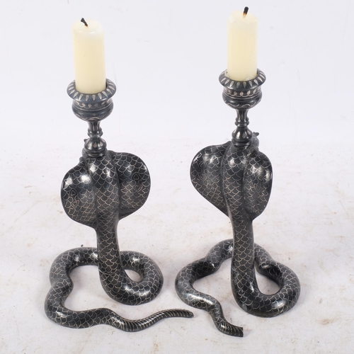 447 - A pair of Indian silver inlaid Bidri cobra candlesticks, 19cm