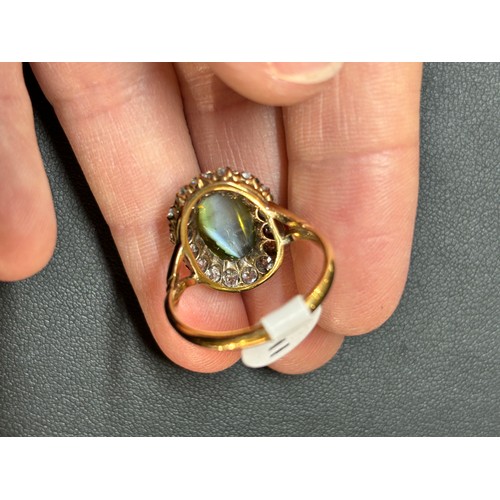 1103 - An Antique 18ct gold cat's eye chrysoberyl and diamond cluster ring, late 19th century, set with a 4... 