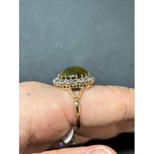 1103 - An Antique 18ct gold cat's eye chrysoberyl and diamond cluster ring, late 19th century, set with a 4... 