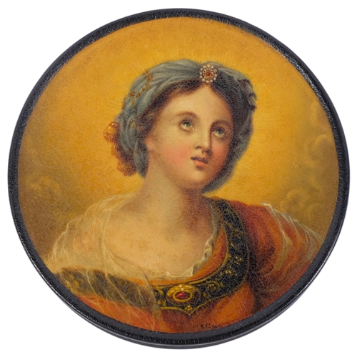 679 - A Victorian black lacquered papier mache circular box and cover, with printed portrait of a young la... 