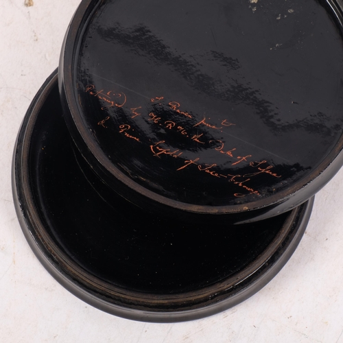 679 - A Victorian black lacquered papier mache circular box and cover, with printed portrait of a young la... 