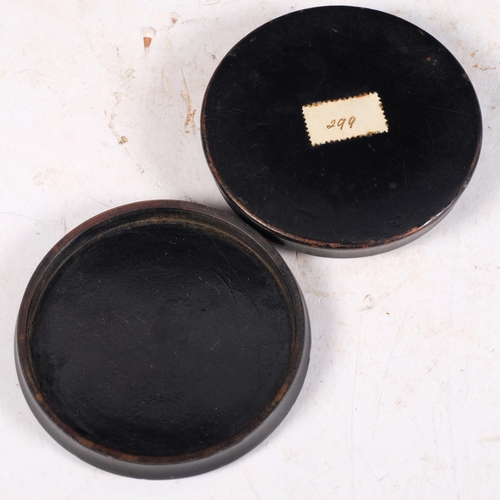 681 - A Victorian black lacquered papier mache circular box and cover, the decorated printed top depicting... 