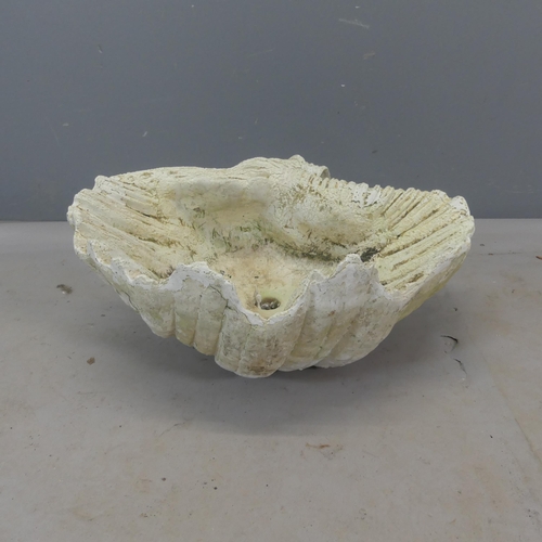 2484 - A weathered fibreglass shell-design planter. Width 55cm, height 25cm, depth 46cm.