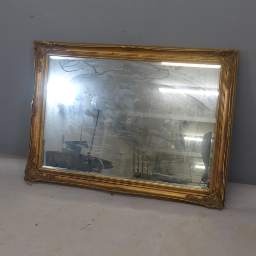 2488 - A resin gilt-framed rectangular wall mirror. Width 106cm, height 75cm.