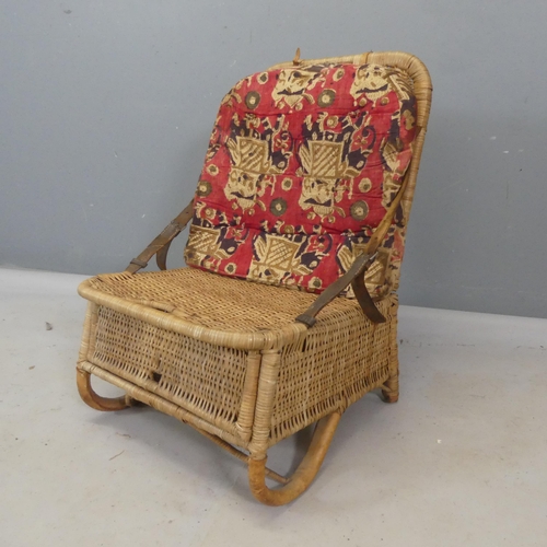 2493 - A campaign style wicker folding chair with integrated compartment with lifting lid.