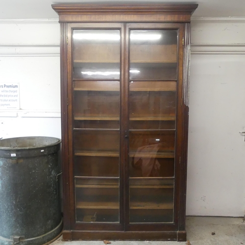 2495 - A Victorian mahogany library bookcase, with two glazed doors and sliding shelves. Width 125cm, heigh... 