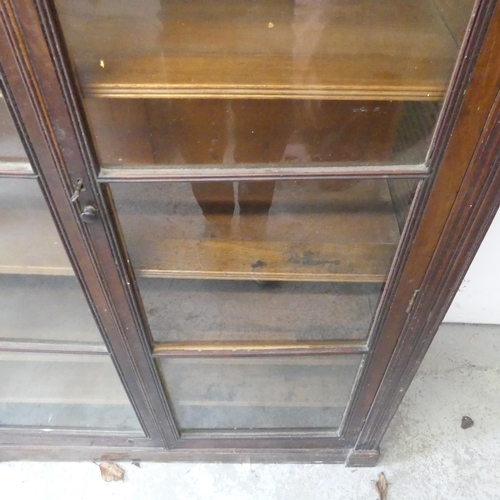 2495 - A Victorian mahogany library bookcase, with two glazed doors and sliding shelves. Width 125cm, heigh... 