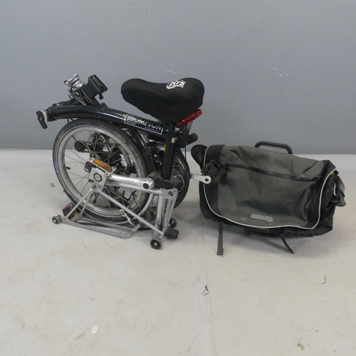 2504 - BROMPTON - A folding bicycle with mounted luggage rack and carry case.