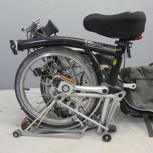 2504 - BROMPTON - A folding bicycle with mounted luggage rack and carry case.