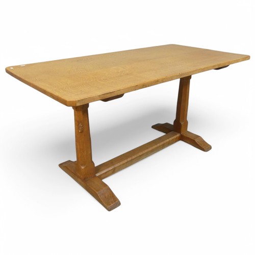 ROBERT MOUSEMAN THOMPSON - An oak refectory style dining table, with 3cm thick plank top, raised on octagonal end column supports with carved mouse and stretcher base. Length 151cm, height 75cm, width 75cm.