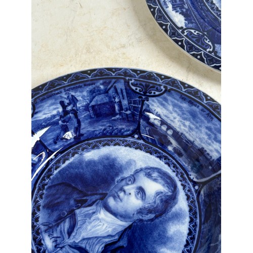 256 - A pair of Staffordshire portrait plaques, depicting Burns and Dickens, and a Japanese blue and white... 