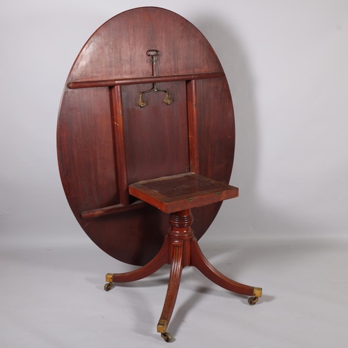 502 - A Regency oval mahogany tilt-top dining table, on quadruple base, 152cm x 119cm (5' x 3'11