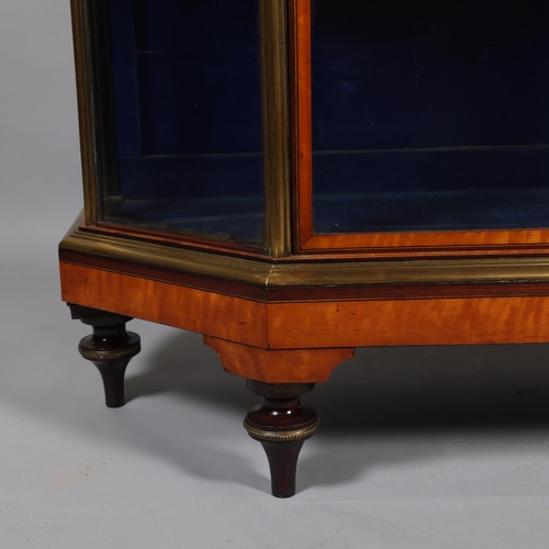 512 - A Victorian satinwood mahogany and brass-edge display cabinet, with canted corners and turned feet, ... 