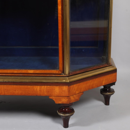 512 - A Victorian satinwood mahogany and brass-edge display cabinet, with canted corners and turned feet, ... 