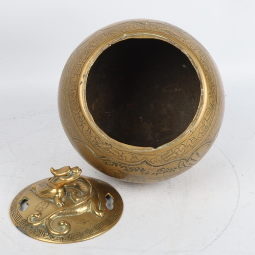 404 - A Chinese brass incense burner and cover, with engraved decoration and dragon mounted lid, height 19... 