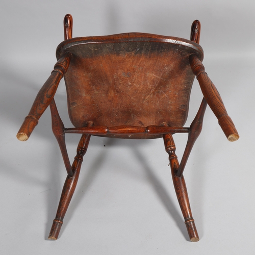 499 - An early 19th century yew wood bow arm Windsor chair, with Prince of Wales Feather design splat and ... 