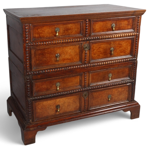 500 - An 18th century oak and walnut chest of drawers, in 2 parts, with moulded panelled drawer fronts and... 