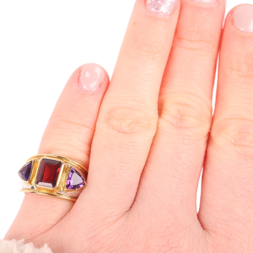 1106 - THEO FENNELL - an 18ct two-colour gold three stone garnet and amethyst bombe ring, London 1991, rub-... 