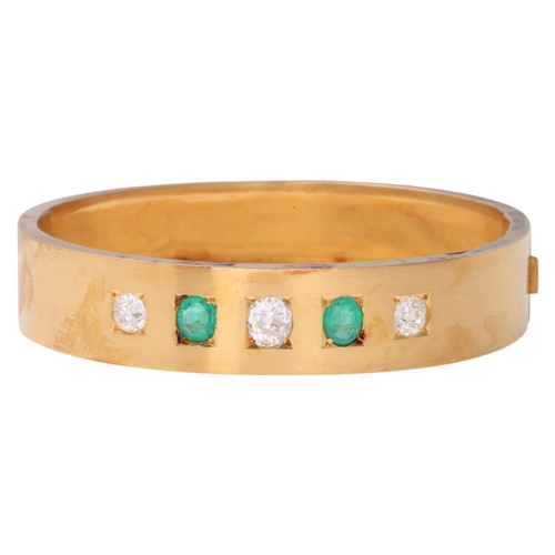 1128 - An Antique Victorian 18ct gold five stone emerald and diamond hinged bangle, circa 1860, square set ... 